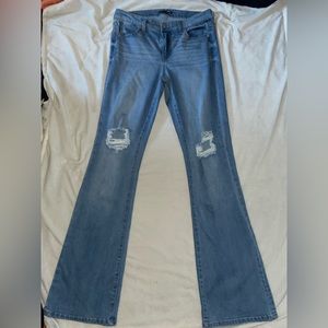 Flare bottom ripped blue jeans